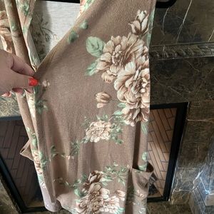 Floral vest. Pockets. Feels like puppy fur.  Never worn.  Fits up to a 2X